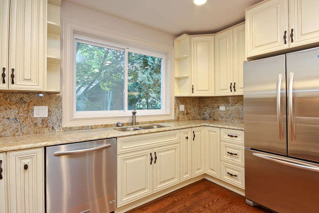 1035 Willow Road Winnetka, IL 60093 - Photo 5 of 25 a kitchen with white cabinets and white appliances