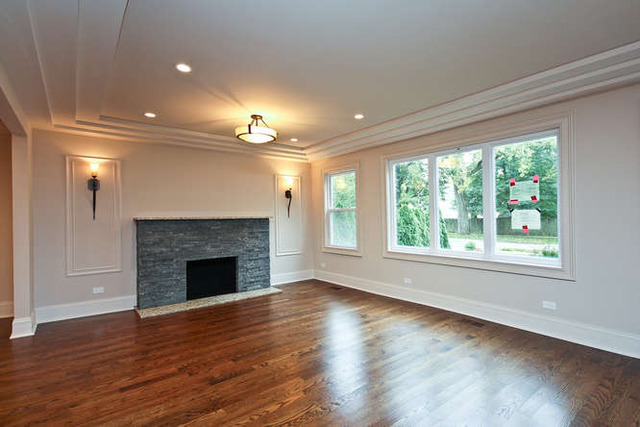 1035 Willow Road Winnetka, IL 60093 - Photo 9 of 25 an empty room with wooden floor fireplace and windows