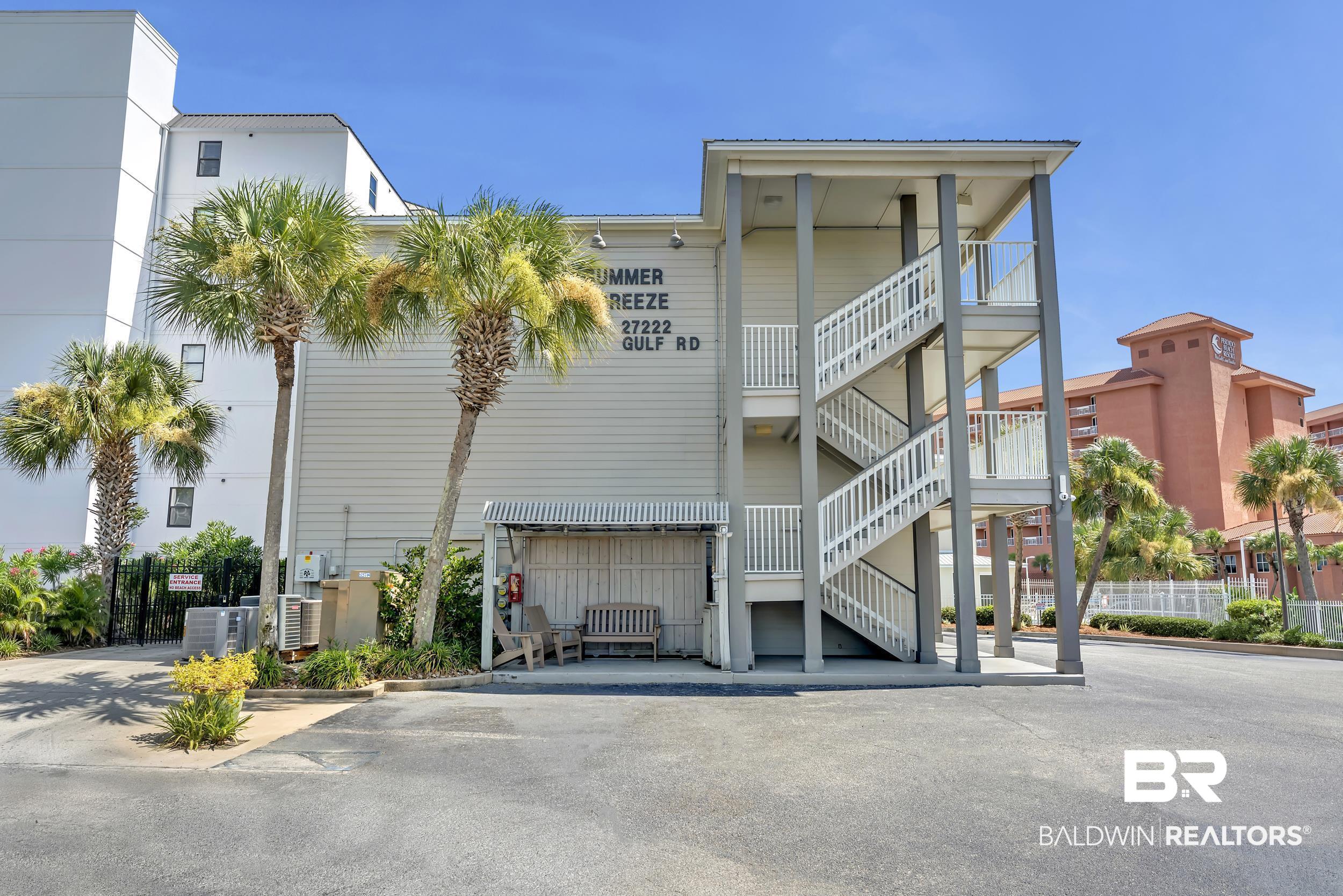 27222 Gulf Road, Unit 33 Orange Beach, AL 36561 - Photo 5 of 29 Multi-story residential structure featuring exterior staircases and a covered entrance