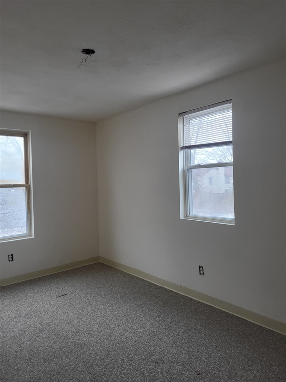 947 River Street, Unit 3 Boston, MA 02136 - Photo 7 of 8 an empty room with a window