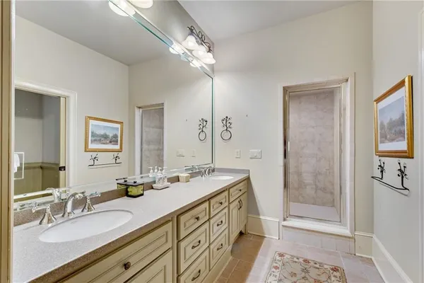 a bathroom with a double vanity sink a mirror and a shower