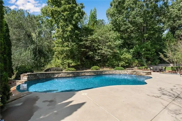 a view of a swimming pool with a yard