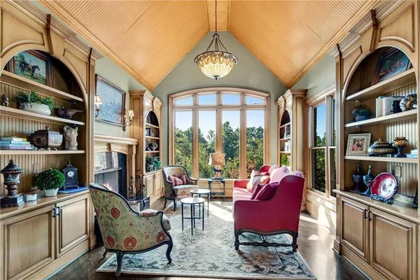 a view of a dining room with furniture a rug and a floor to ceiling window