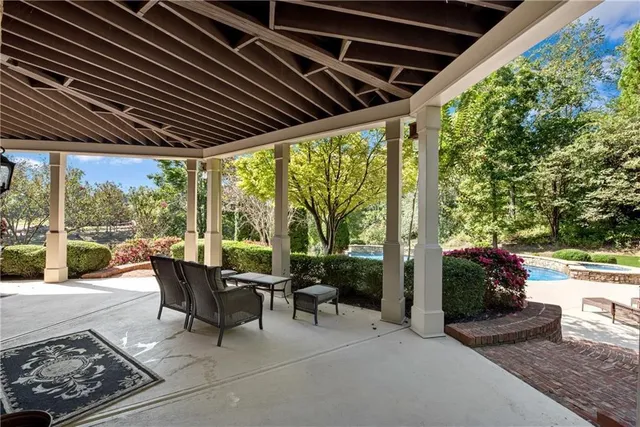 a patio with yard glass top table and chairs