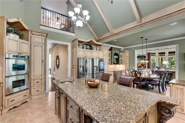 a living room with stainless steel appliances kitchen island granite countertop furniture and a kitchen view