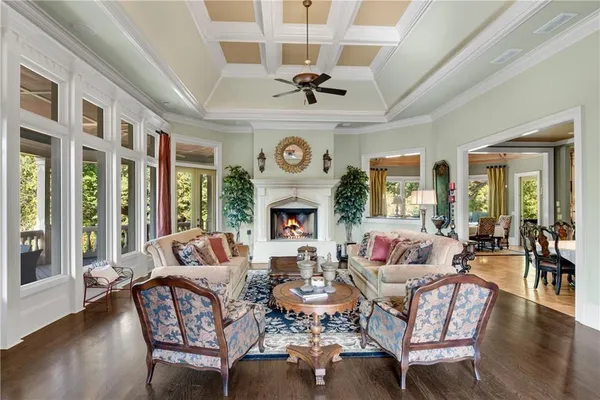 a living room with fireplace furniture and a large window