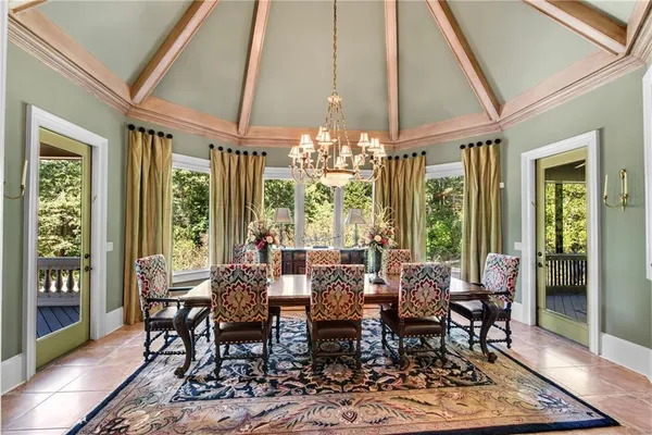a view of a dining room with furniture large windows and wooden floor