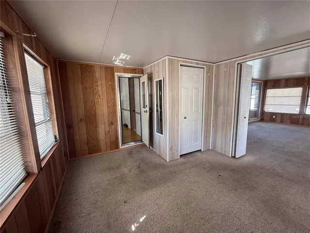 a view of a hallway with furniture and a window