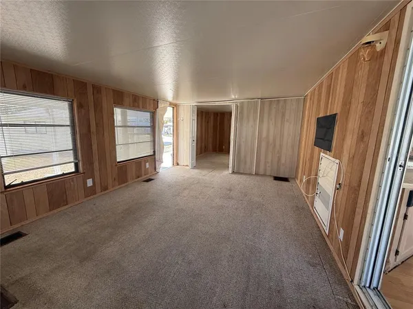 a view of a livingroom with wooden floor and window