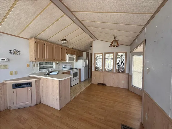 a kitchen with stove and cabinets