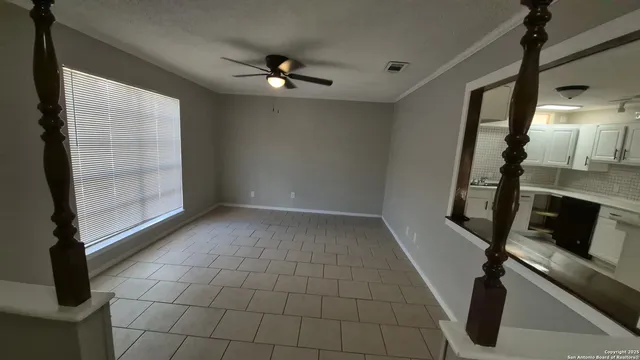a view of empty room with wooden floor