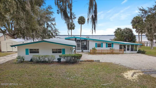 a living room with furniture and floor to ceiling windows