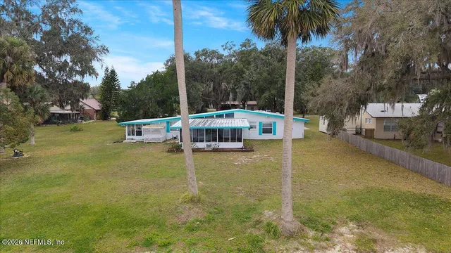 a spacious bedroom with a large bed and a chandelier