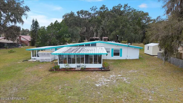 a bedroom with a bed and a view of kitchen