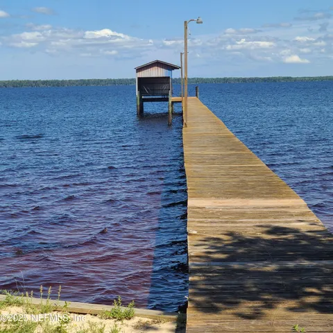 a spacious bathroom with a granite countertop sink a toilet and a bathtub