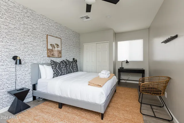 a bedroom with a bed and chair