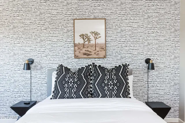 a bedroom with a bed and a window