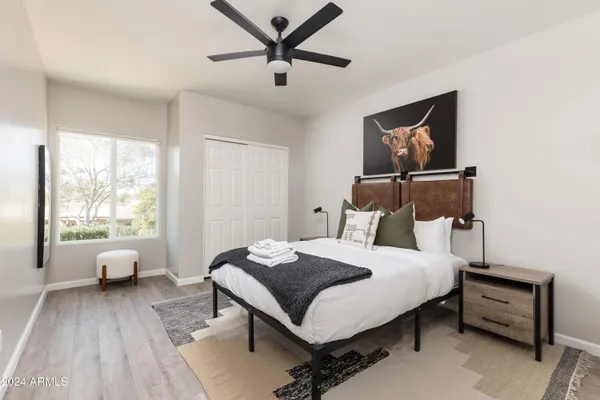 a bedroom with a bed and a window