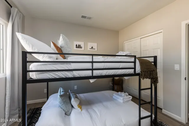 a bedroom with a bed lamp and a window