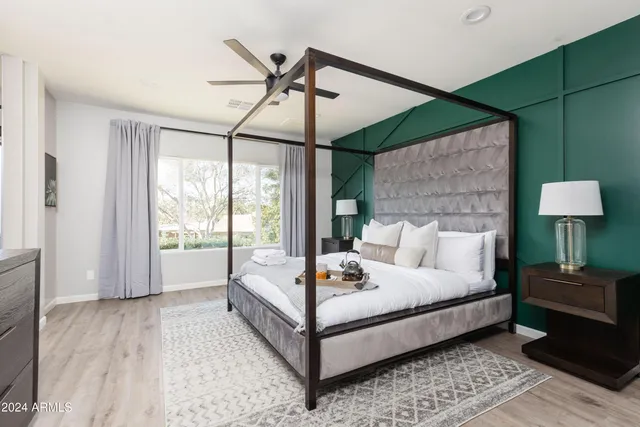 a bedroom with a beds and a chair