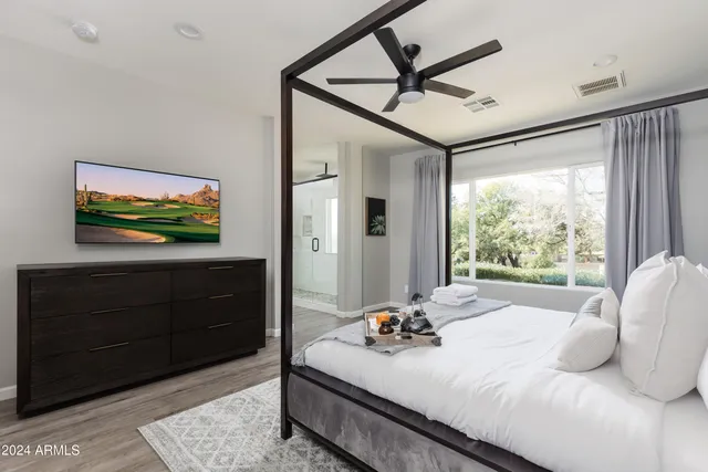 a bedroom with a bed and a view of bathroom