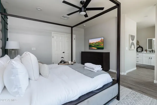 a bathroom with white cabinets and a sink