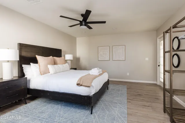 a bedroom with a bed and a lamp