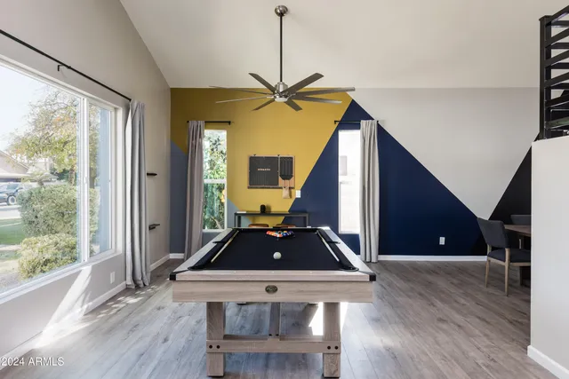 a large white kitchen with a table and chairs in it