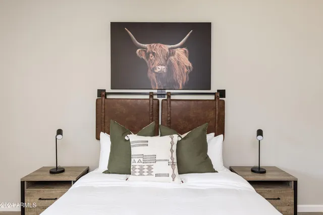 a bed room with a bed and a potted plant