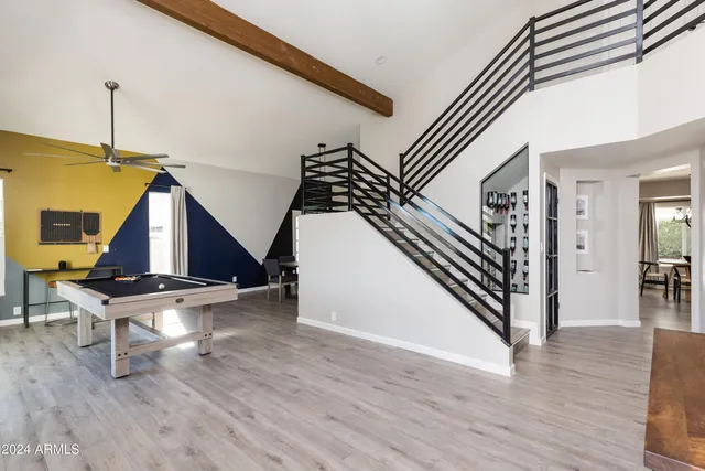 a open kitchen with stainless steel appliances kitchen island granite countertop a sink a stove a dining table and chairs