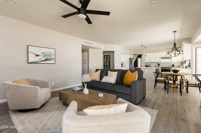 a living room with furniture a fireplace and a window