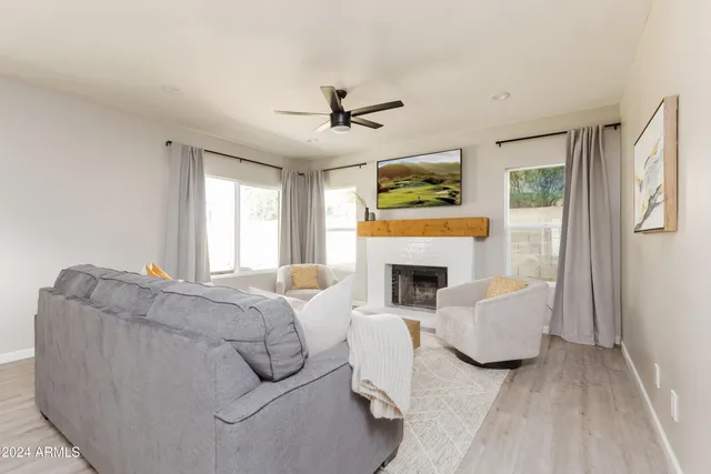 a living room with furniture and a wooden floor