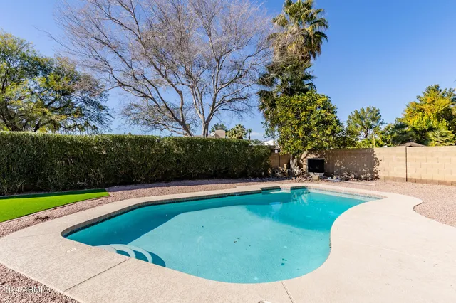 a view of a swimming pool with a yard