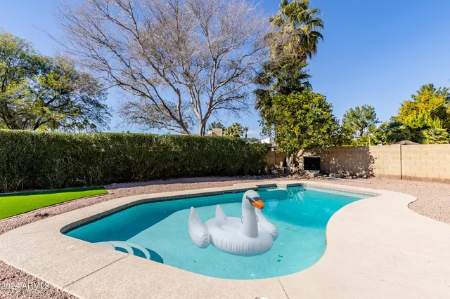 a view of a house with swimming pool and porch