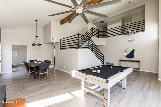 a living room with wooden floor and furniture