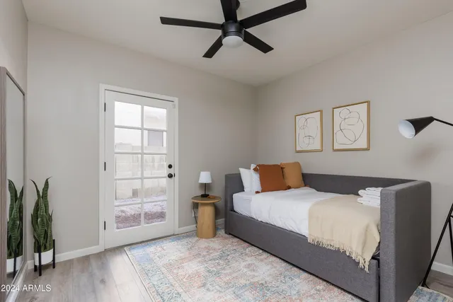 a bedroom with a large bed and a potted plant