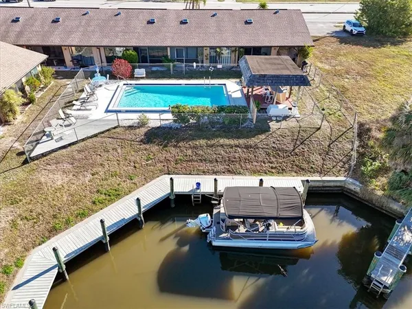 a living room with furniture and view of kitchen