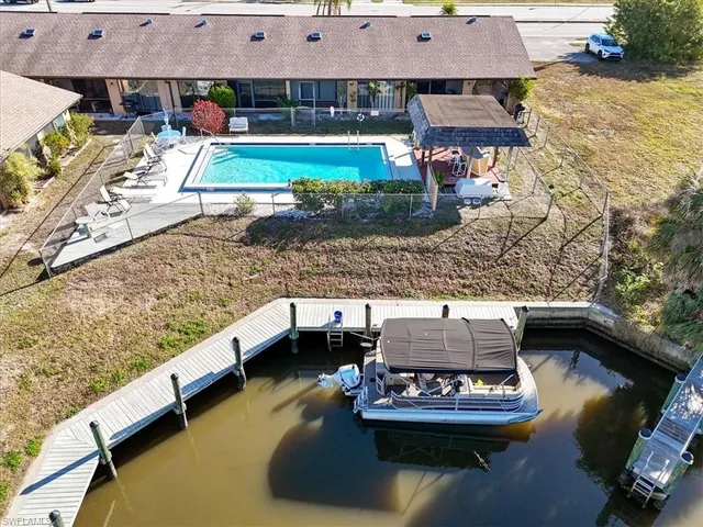a living room with furniture and view of kitchen