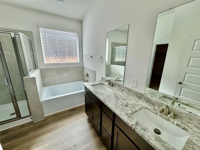 a bathroom with a tub sink and mirror
