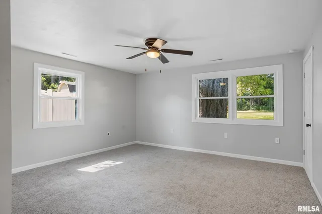 a view of a livingroom with a ceiling fan and window