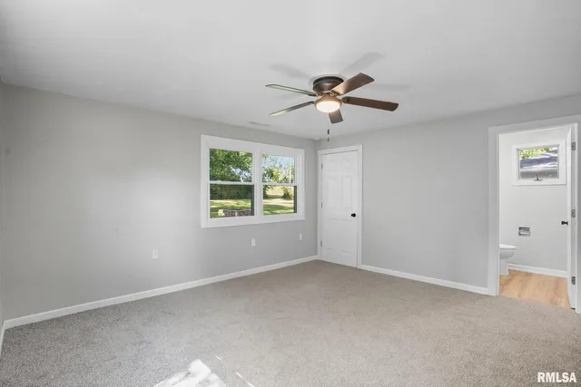 a view of room with a ceiling fan and window