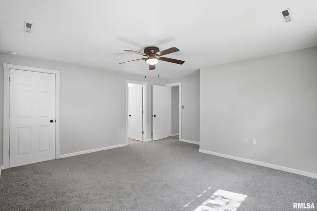 a view of an empty room with a ceiling fan
