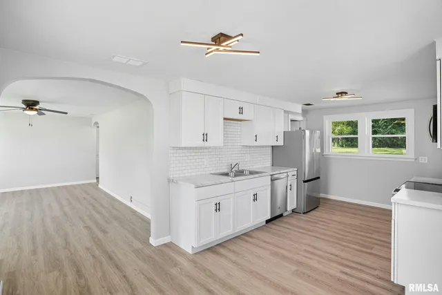 a kitchen with a stove a sink and a refrigerator