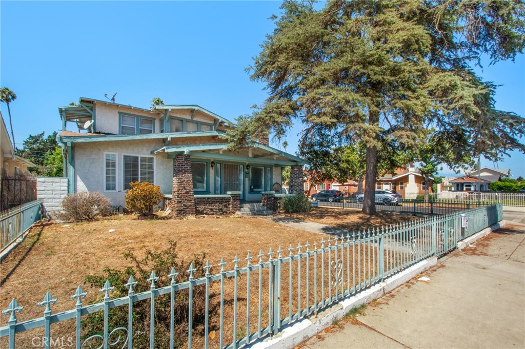 4301 Arlington Avenue Los Angeles, CA 90008 - Photo 1 of 18 a front view of house with yard slide and large trees