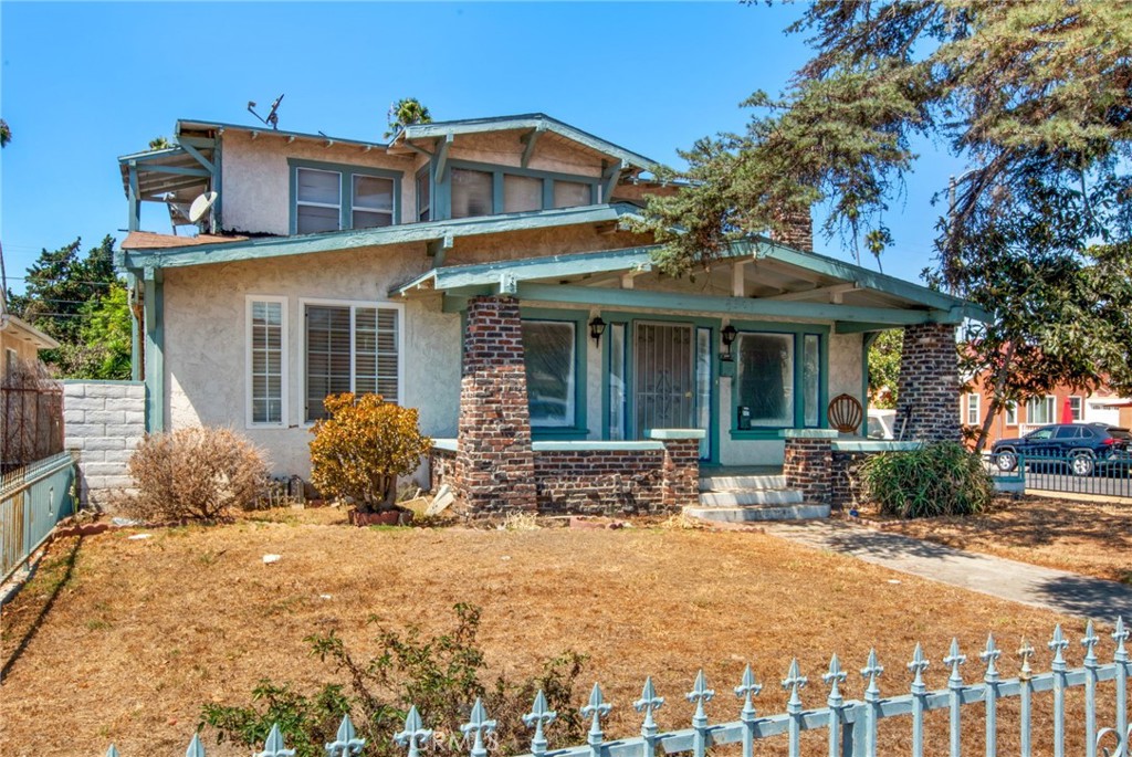 4301 Arlington Avenue Los Angeles, CA 90008 - Photo 2 of 18 a front view of a house with large garden and outdoor seating