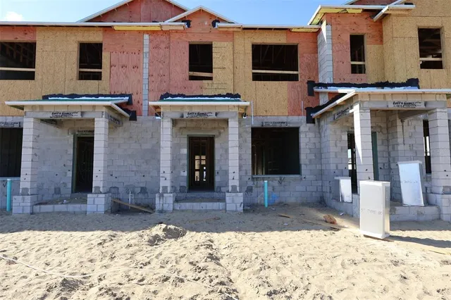 a view of a house with a yard and sitting space
