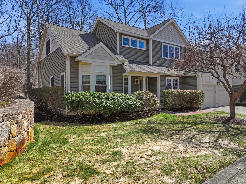 22 McNeil Circle, Unit 22 Hopkinton, MA 01748 - Photo 1 of 42 a front view of a house with a yard