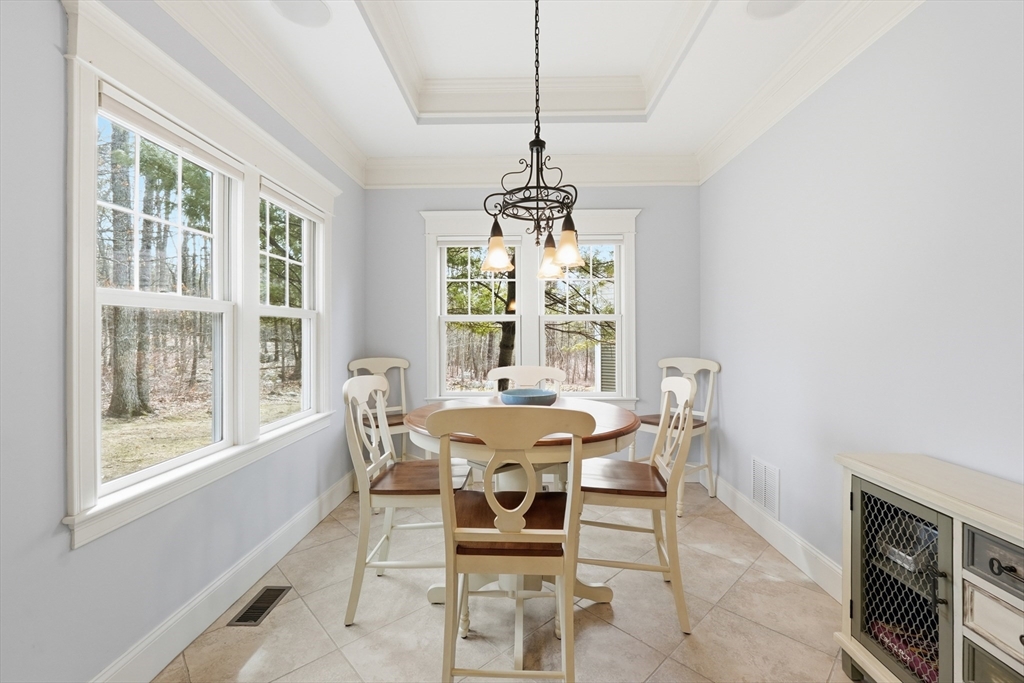 22 McNeil Circle, Unit 22 Hopkinton, MA 01748 - Photo 11 of 42 a dining room with furniture a chandelier and wooden floor