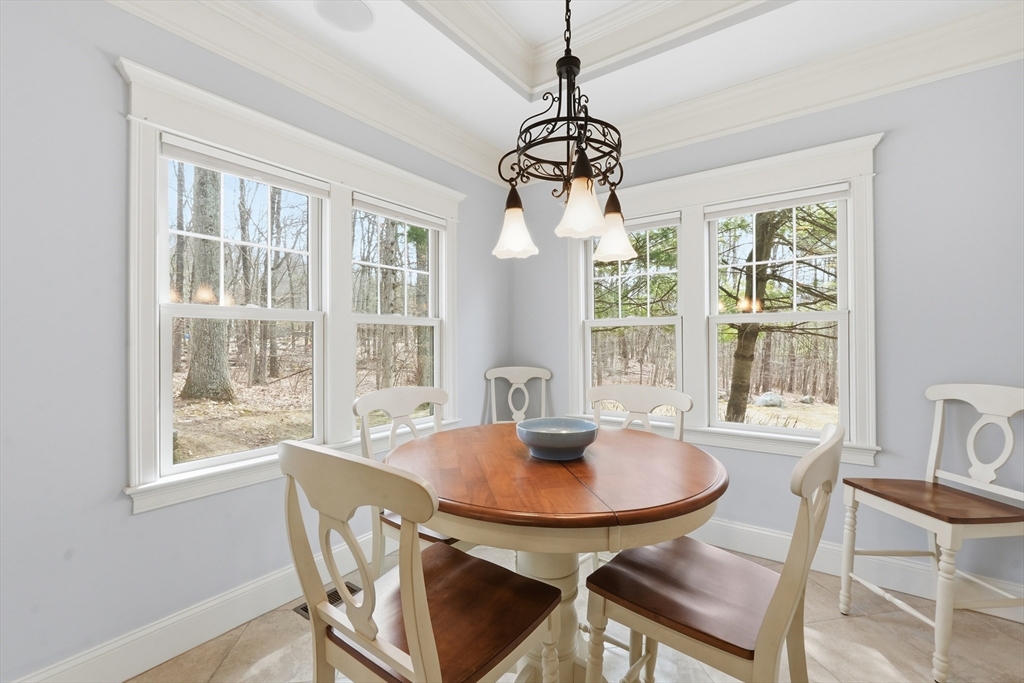 22 McNeil Circle, Unit 22 Hopkinton, MA 01748 - Photo 12 of 42 a dining room with furniture a chandelier and wooden floor