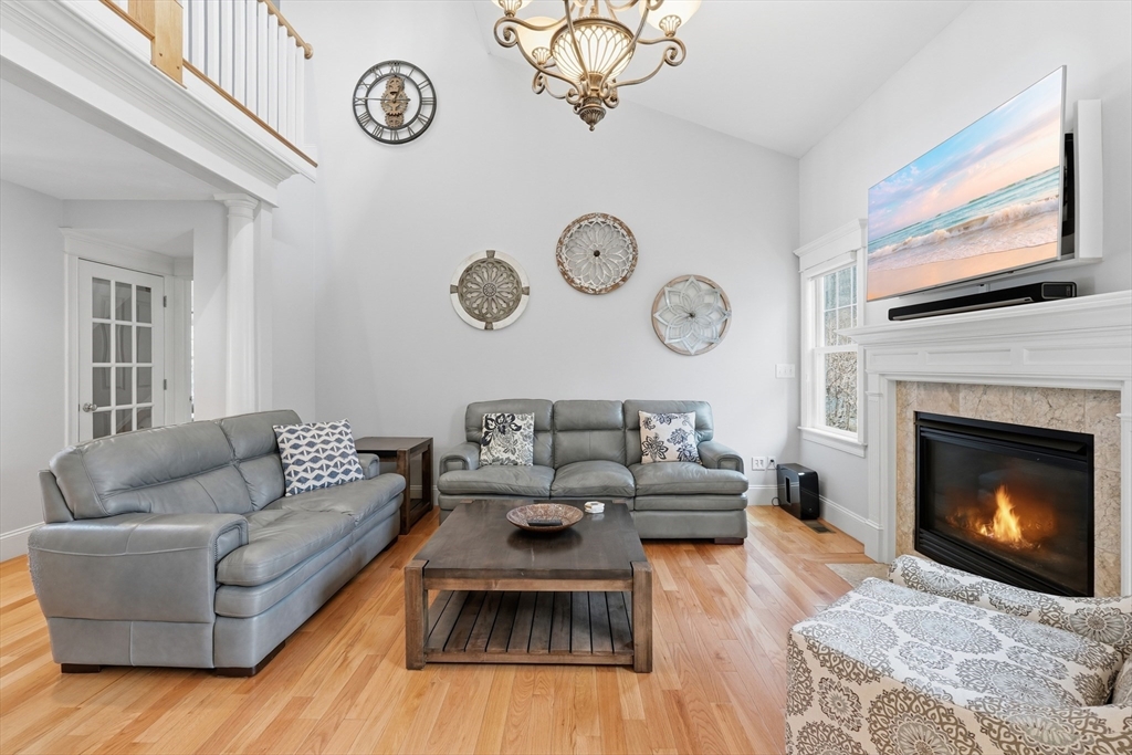 22 McNeil Circle, Unit 22 Hopkinton, MA 01748 - Photo 15 of 42 a living room with furniture and a fireplace